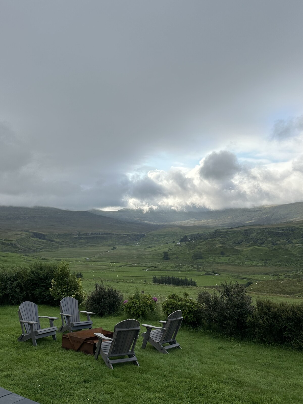 Garden seating and fire pit overlooking the valley at Gleann Síth House