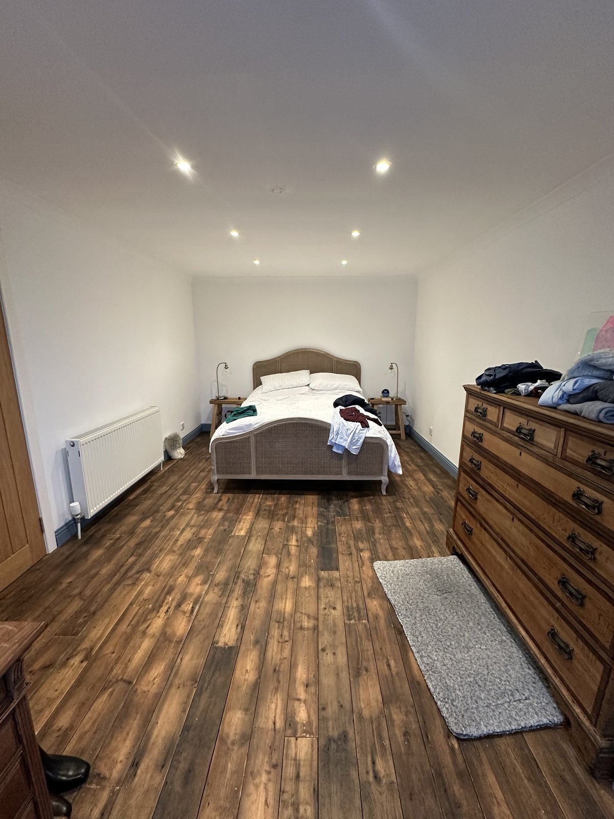Master bedroom with a king-size bed and antique dresser at Gleann Síth House
