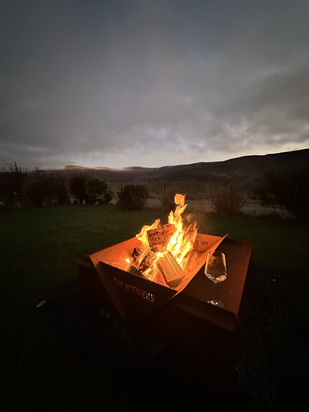Fire pit at dusk in the garden at Gleann Síth House