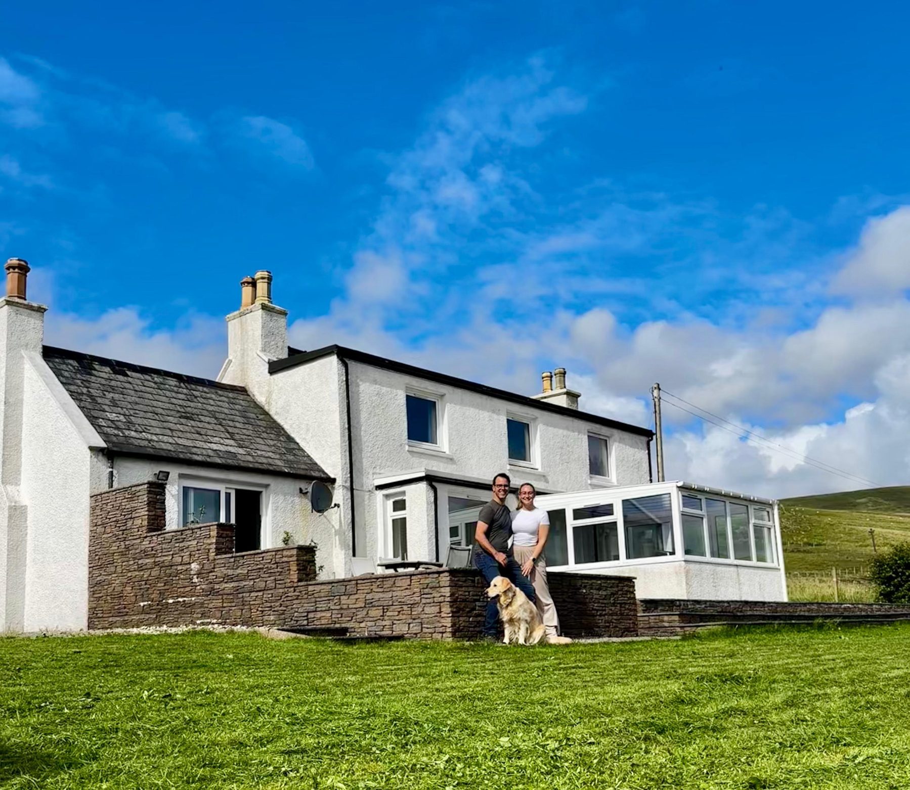 The owners of Gleann Síth House outside the property with their dog