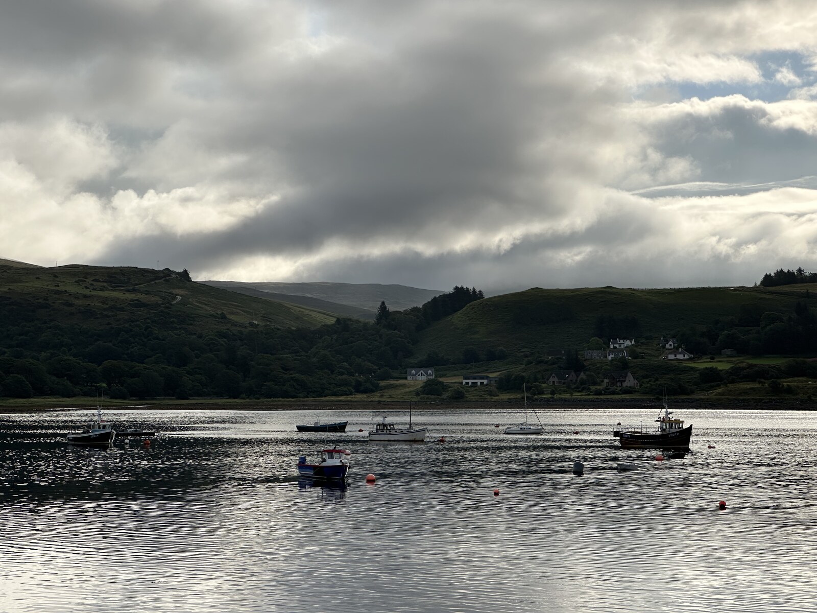 Fishing boats moored in Uig harbour at dusk