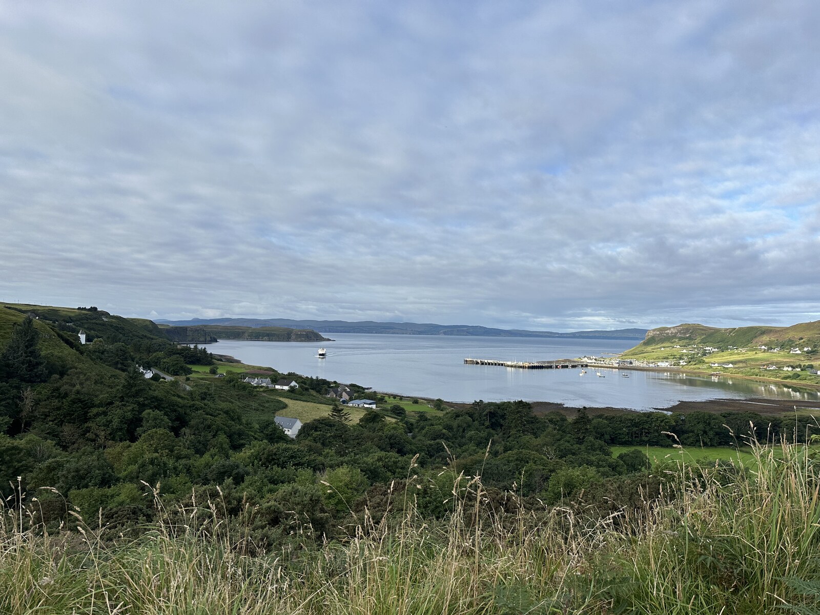 Uig harbour under cloud, with the ferry departing